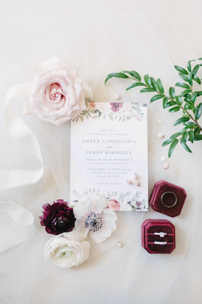 Floral wedding invitation styled with roses and burgundy ring box captured by Christina Elliott Photography