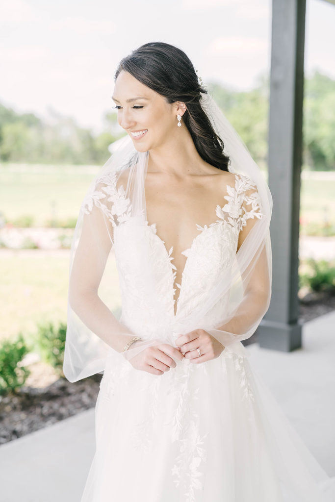 Classic and elegant bride with white lace wedding dress and full skirt by Christina Elliot Photography in Houston, TX. alvin tx still waters ranch event venue brazoira county wedding dress inspo classic wedding dresses sheer wedding dresses lace wedding dresses cap sleeve wedding dresses lace sleeve wedding dress outdoor bridal photoshoot #houstontexasphotographer #alvintxweddingphotographer #texasweddingphotography #outdoorbridalformals #bridalphotography