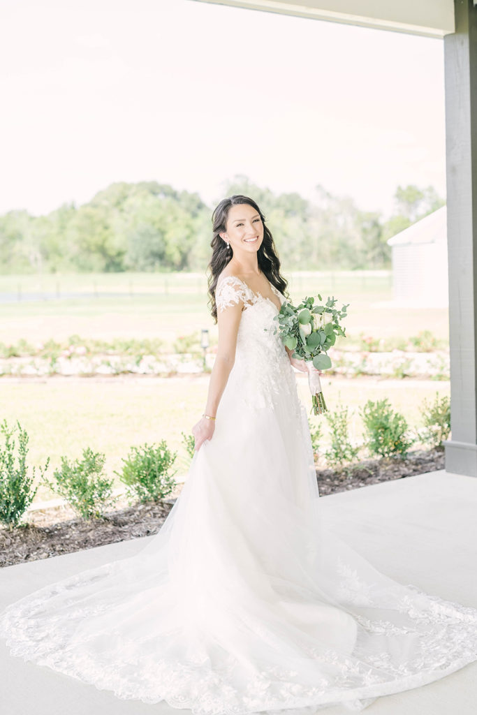 Beautiful bride in cap-sleeved wedding white wedding dress with white and green floral wedding bouquet in Houston, TX by Christina Elliot Photography. bridal hair inspo bridal flower bouquet inspo smaller bridal bouquet wedding dress inspo outdoor photoshoot locations in texas alvin, tx brazoria county houston wedding photographer #houstontexasphotographer #alvintxweddingphotographer #texasweddingphotography #outdoorbridalformals #bridalphotography