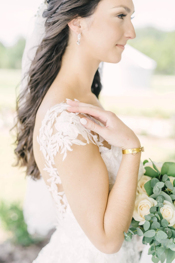 Close up detail shot of bride with gold accent jewelry and a beautiful white nail manicure for her formals in Alvin, TX by Christina Elliot Photography. wedding jewelry inspo gold jewelry for wedding simple jewelry for wedding classing jewelry for wedding gold nails for bridals nails for wedding classic wedding nails manicure for bridals #houstontexasphotographer #alvintxweddingphotographer #texasweddingphotography #outdoorbridalformals #bridalphotography