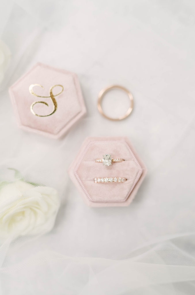 Beautiful gold diamond ring with diamond band for bride and simple gold ring for groom in this detail shot by Christina Elliot in Houston, TX. wedding ring inspo gold wedding rings gold wedding bands for groom engagement ring inspo wedding ring band inspo gold and diamond wedding rings his and her wedding rings tx greenhouse oak atelier woodlands #houstontexasphotographer #houstonweddingphotographer #texasweddingphotography #greenhousewedding #outdoorweddinginspo