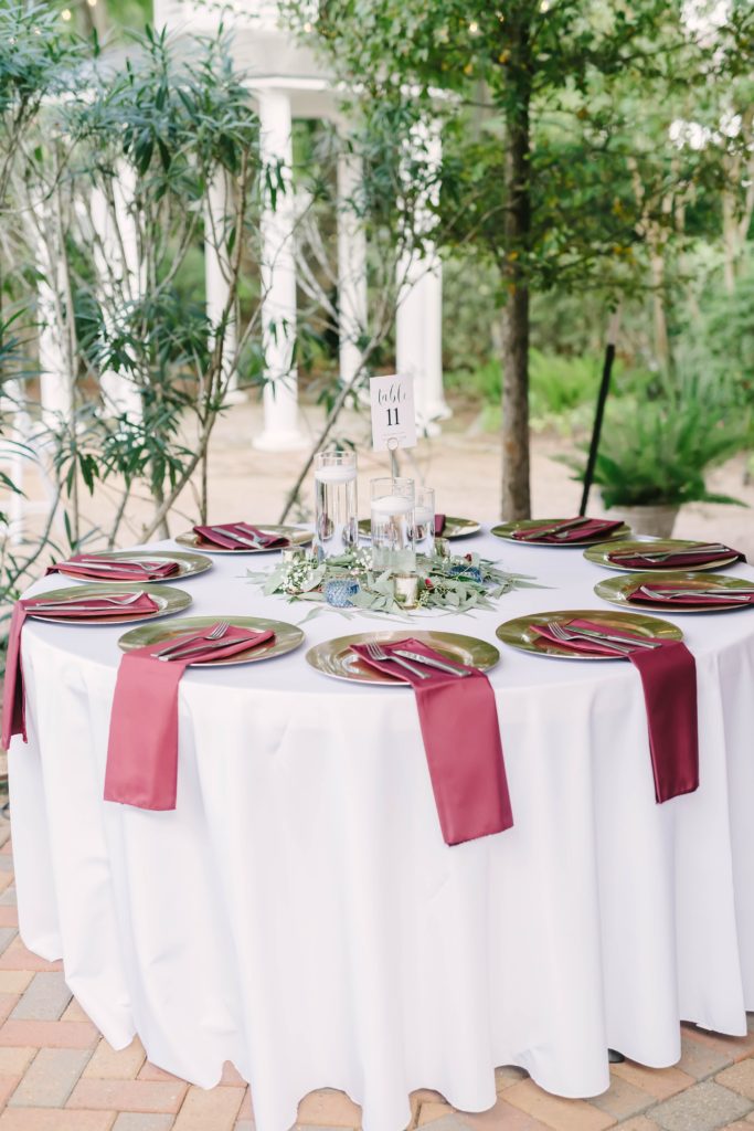 Table settings at a gorgeous summer wedding at Butler’s Courtyard in League City, Texas. Christina Elliot Photography wedding and couples photographer texas based houston couples table setting inspo red wedding colors classy table centerpiece