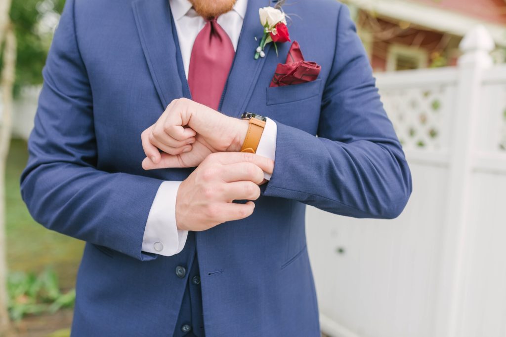 Detail shot of the groom adjusting his watch before his wedding ceremony captured by Christina Elliott Photography. League City wedding venue summer weddings texas couples poses for men Butler’s Courtyard masculine poses for groomsmen