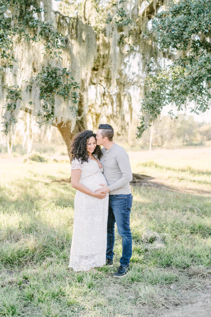 During this Houston, Texas maternity session, Christina Elliott Photography captures this soon-to-be father kiss his expectant wife's cheek. winter Houston Texas maternity session photographer man kissing wife's cheek #HoustonMaternityPhotographer #HoustonCouplesPhotographer #HoustonPhotographer #MaternitySession #MaternityDresses #ChristinaElliottPhotography #HoustonFamilyPhotographer #Pregnant #BabyBump #WereExpecting