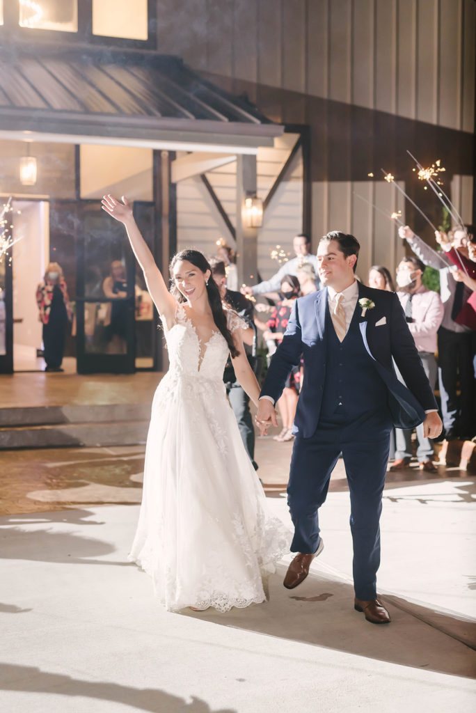 A sparkler send off at this barn style wedding in Houston, Texas with Christina Elliot Photography. Sparkler send off inspo picture pose bride and groom white lace dress happy marriage candid moment celebrate navy blue suit alvin texas wedding photographer #houstonweddingphotographer #texasphotographer #weddingdaydetails #barnstylewedding #stillwatersranch #alvintexasphotographer #weddingday #brideandgroom #texanwedding #htxwedding #countrywedding