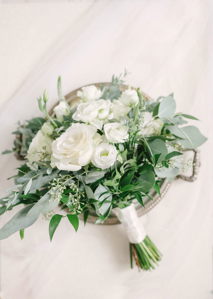 A beautiful close-up shot of the brides wedding bouquet on her big day at Still Waters Ranch in Alvin, Texas captured by Christina Elliot Photography. Bridal bouquet flowers wedding day inspo houston texas photographer haute flower design still waters ranch barn style silver platter details #houstonweddingphotographer #texasphotographer #weddingdaydetails #barnstylewedding #stillwatersranch #alvintexasphotographer #weddingday #brideandgroom #texanwedding #htxwedding #countrywedding
