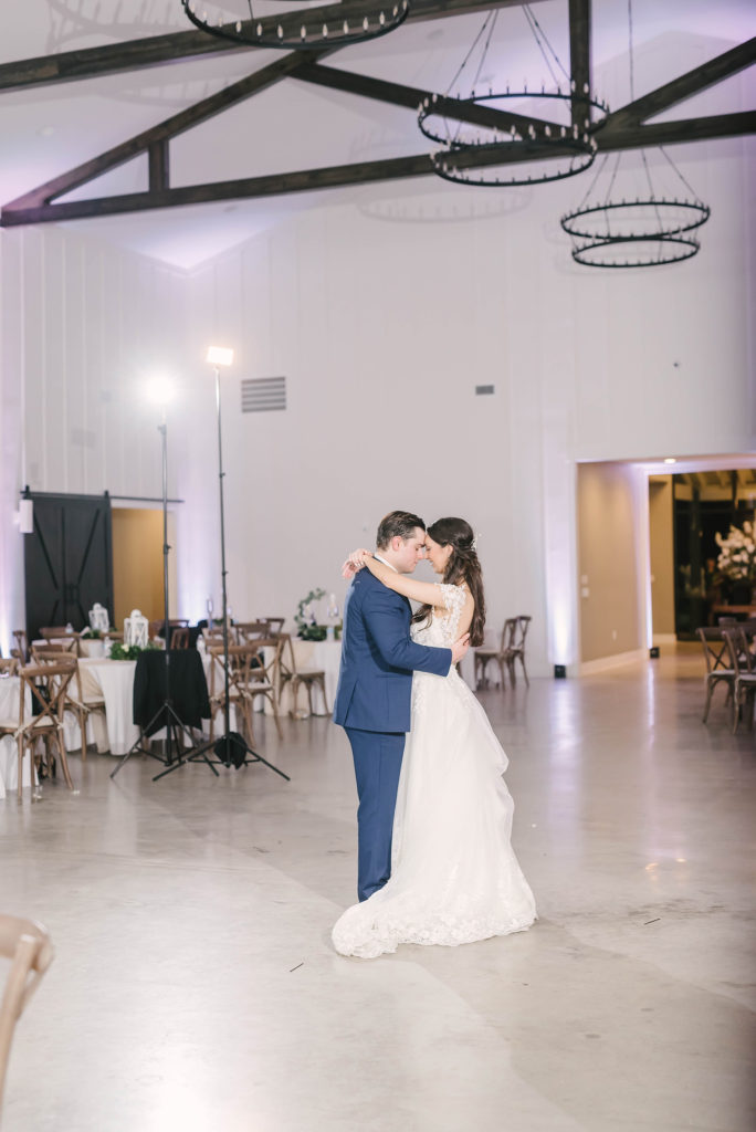 Husband and wife share their first dance in this Houston Texas barn style wedding captured by Christina Elliot Photography. Tender moments first dance husband and wife bride and groom white lace wedding dress floral lace country wedding still waters ranch barn inspo texas photographer #houstonweddingphotographer #texasphotographer #weddingdaydetails #barnstylewedding #stillwatersranch #alvintexasphotographer #weddingday #brideandgroom #texanwedding #htxwedding #countrywedding