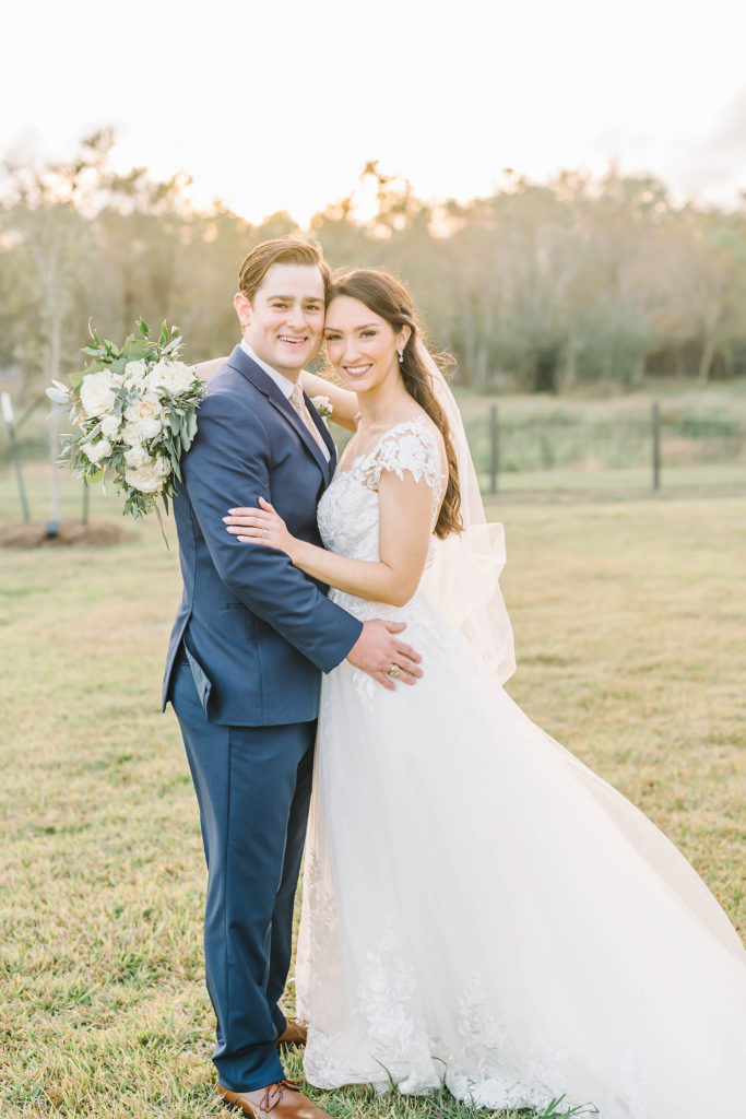 This bride and groom are all smiles on their wedding day in Alvin, Texas with Christina Elliot Photography. Smiles bride and groom wedding picture bridals inspo houston texas wedding photographer white lace dress white flowers floral bouquet outdoor photos inspiration #houstonweddingphotographer #texasphotographer #weddingdaydetails #barnstylewedding #stillwatersranch #alvintexasphotographer #weddingday #brideandgroom #texanwedding #htxwedding #countrywedding