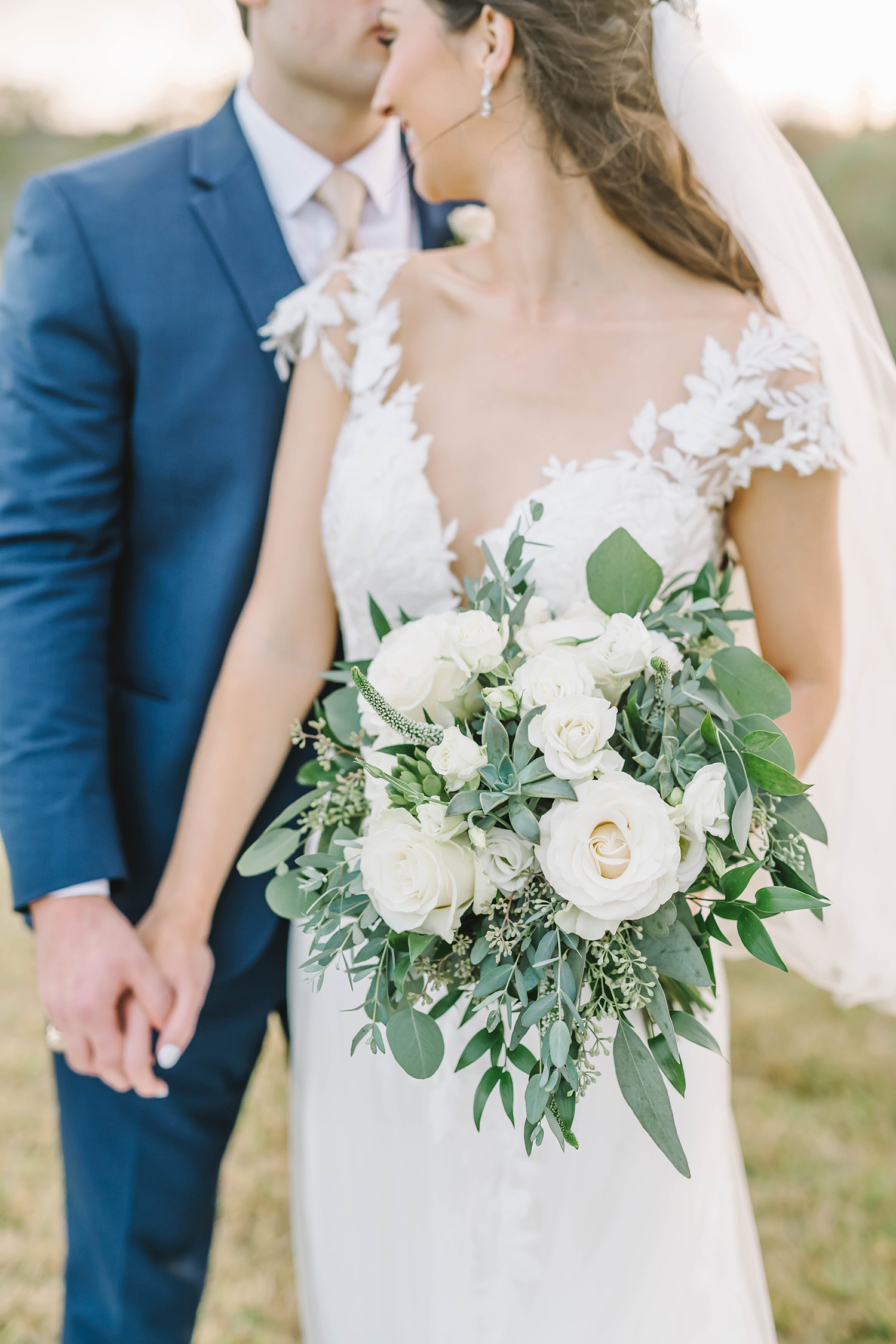 A kiss on the forhead before the wedding ceremony in this stunning barn style wedding in Alvin, Texas with Christina Elliot Photography. Kiss on the forehead bride and groom photo pose inspo wedding day diamond earrings neutral greenery white flower bouquet #houstonweddingphotographer #texasphotographer #weddingdaydetails #barnstylewedding #stillwatersranch #alvintexasphotographer #weddingday #brideandgroom #texanwedding #htxwedding #countrywedding