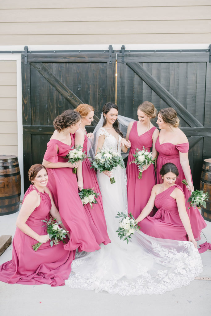 This gorgeous candid moment between a bride and her wedding party on her day in Houstin, Texas with Christina Elliot Photography. Alvin Texas wedding photographer houston still waters ranch barn style wedding bride white wedding dress bridesmaid dress inspo maroon color palette #houstonweddingphotographer #texasphotographer #weddingdaydetails #barnstylewedding #stillwatersranch #alvintexasphotographer #weddingday #brideandgroom #texanwedding #htxwedding #countrywedding