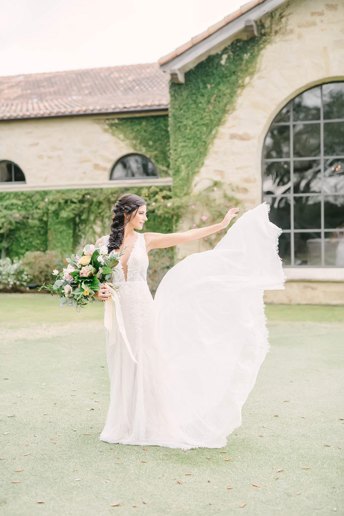 Bride tosses white lace gown during bridal portrait session at the Clubs at Houston Oaks