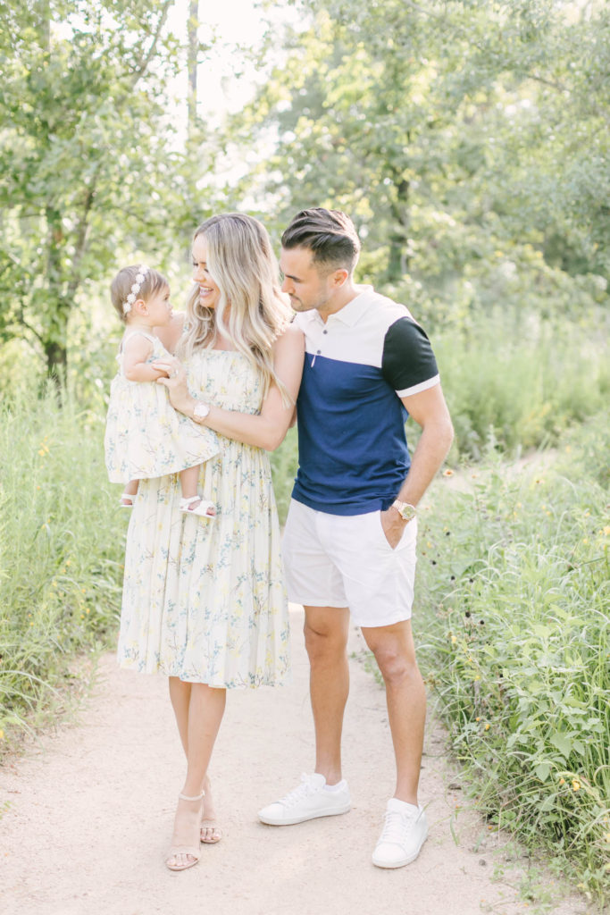 Beautiful family photographed on gravel path path at the Houston Arboretum in near Memorial Park in Houston, TX. Spring family portrait inspo.