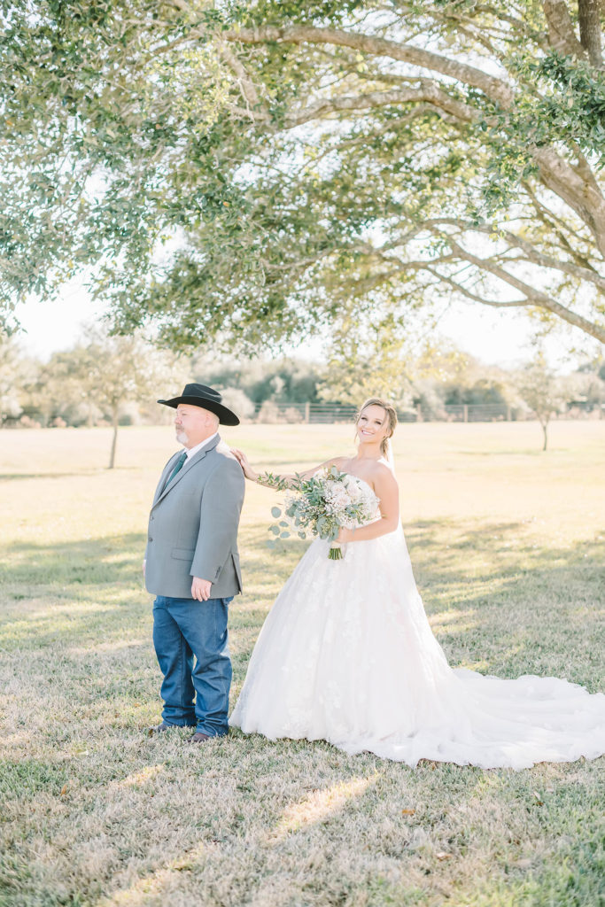 Bride gently taps her father on the shoulder during a special first look moment.