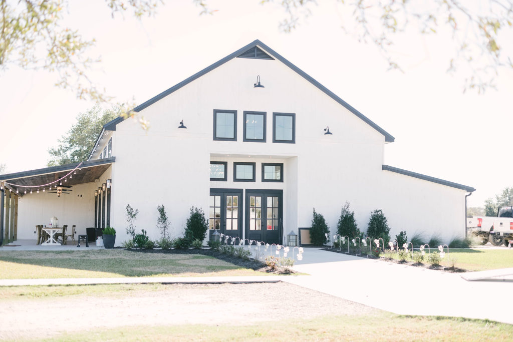 Black and white exterior of the Barn at Willowynn wedding venue in Santa Fe, Texas.
