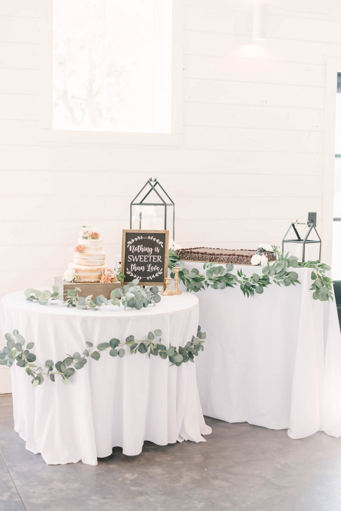 Dessert table with traditional white naked wedding cake