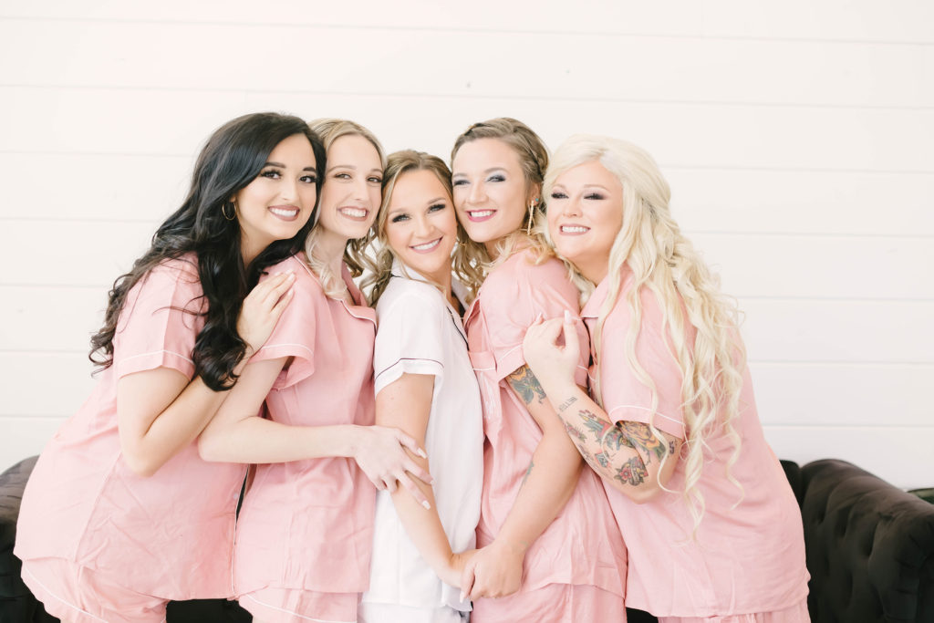 Beautiful bridal party in the blush and white robe set at the Barn at Willowynn.