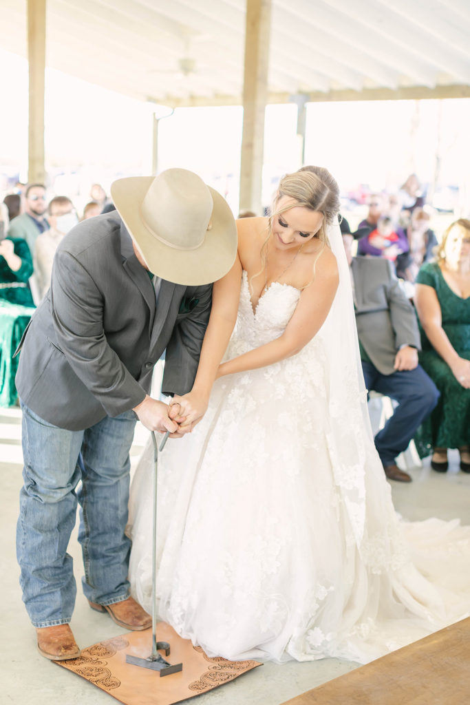 Unique branding ceremony during the vows at the Barn at Willowynn outdoor ceremony space