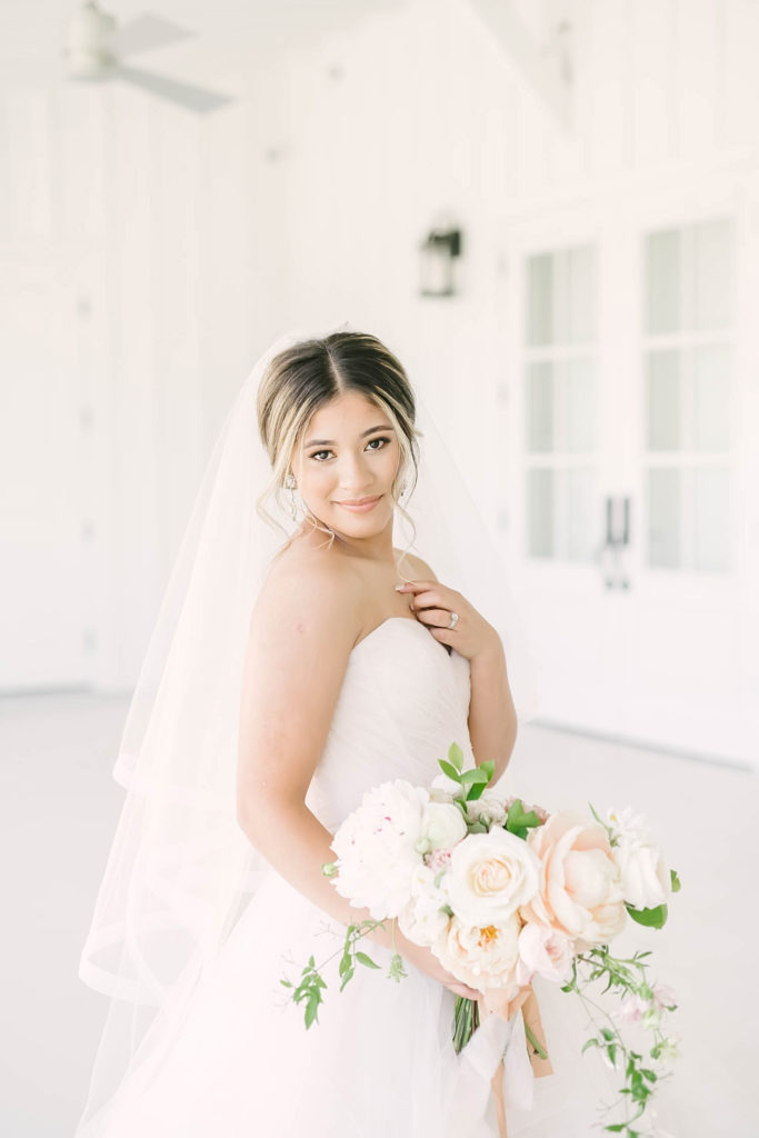 Stunning bridal portrait with a romantic floral bouquet at the Farmhouse Events
