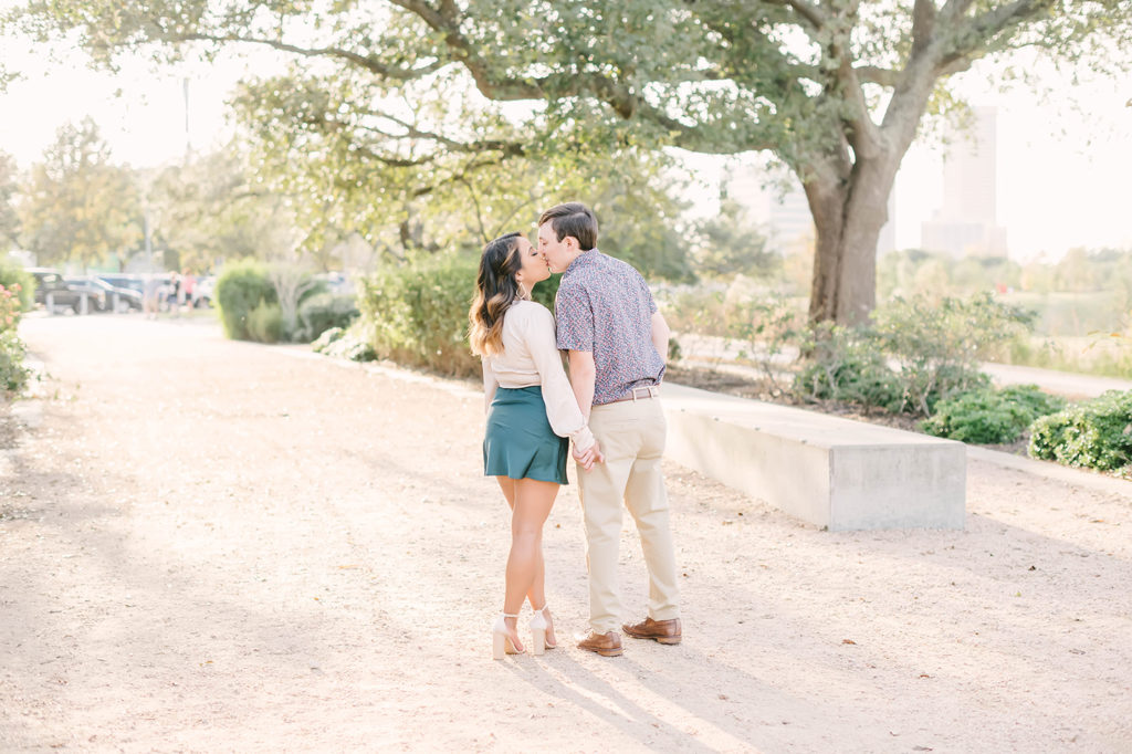 This sweet couple kiss each other during their photoshoot in Houston, Texas captured by Christina Elliot Photography. Parking lot pictures engaged couple she said yes engagement ring black tank teal green skirt downtown Houston texas wedding photographer #christinaelliotphotography #houstonweddingphotographer #engagementpics #houstonphotographer #engagementphotos #shesaidyes #texasphotographer #photoinspiration #weddingphotography #houstonphotographer