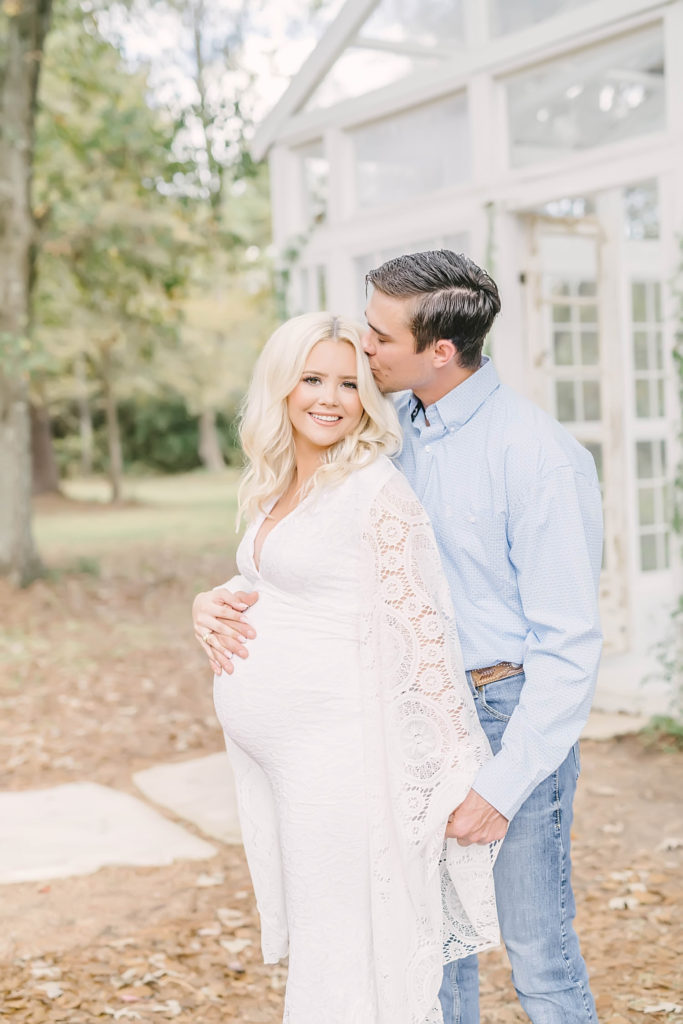 Texas Maternity Photographer captures a husband kissing his pregnant wife's head during an outdoor maternity session. outdoor maternity session loving parents young love #christinaelliottphotography #christinaelliotmaternitysession #babybump #houstonmaternityphotographer #houstonmaternity #pregnancypic #houstonphotographylocations #materntiyoutfit #soontobeparents #babyontheway #houstonphotos #houstontexasmaternityphotographer #oakatelierphotos #conroetexas