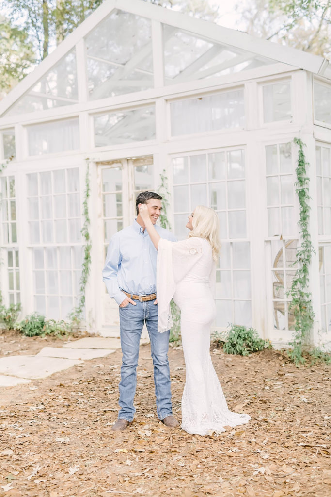 A sweet moment is captured of a pregnant woman fixing her husbands hair during pictures by Christina Elliott Photography in Northern Houston Area. fall bump pic authetic photos #christinaelliottphotography #christinaelliotmaternitysession #babybump #houstonmaternityphotographer #houstonmaternity #pregnancypic #houstonphotographylocations #materntiyoutfit #soontobeparents #babyontheway #houstonphotos #houstontexasmaternityphotographer #oakatelierphotos #conroetexas