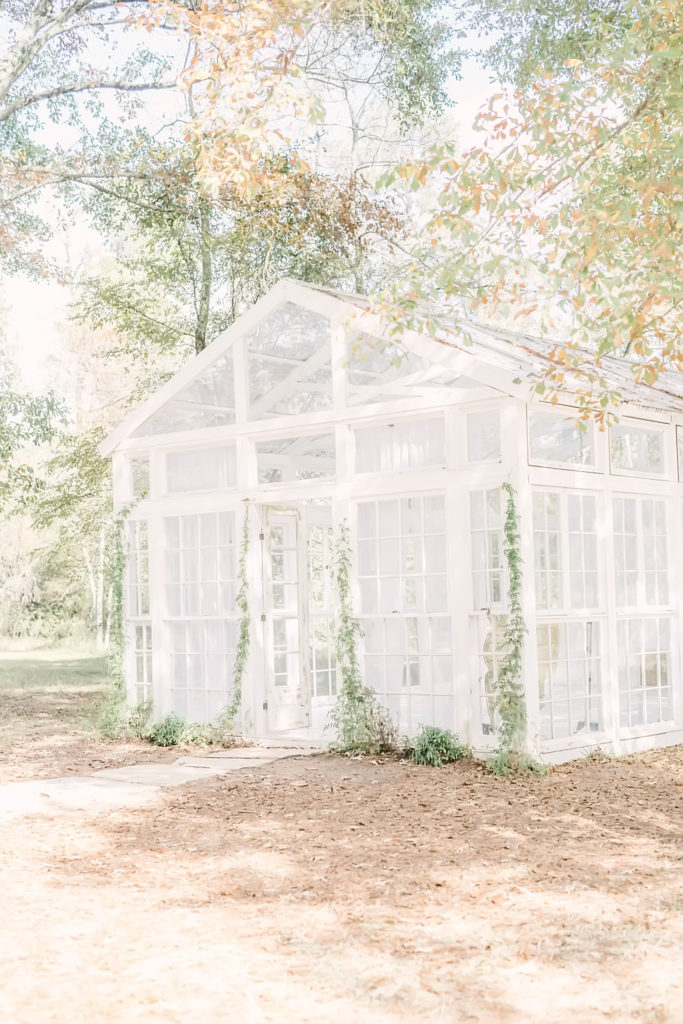 Darling photo of a white greenhouse in the middle of a forest captured in Houston by Christina Elliott Photography. houston photography locations white greenhouse stunning locations in Houston #christinaelliottphotography #christinaelliotmaternitysession #babybump #houstonmaternityphotographer #houstonmaternity #pregnancypic #houstonphotographylocations #materntiyoutfit #soontobeparents #babyontheway #houstonphotography #houstontexasmaternityphotographer #oakatelierphotos #conroetexas