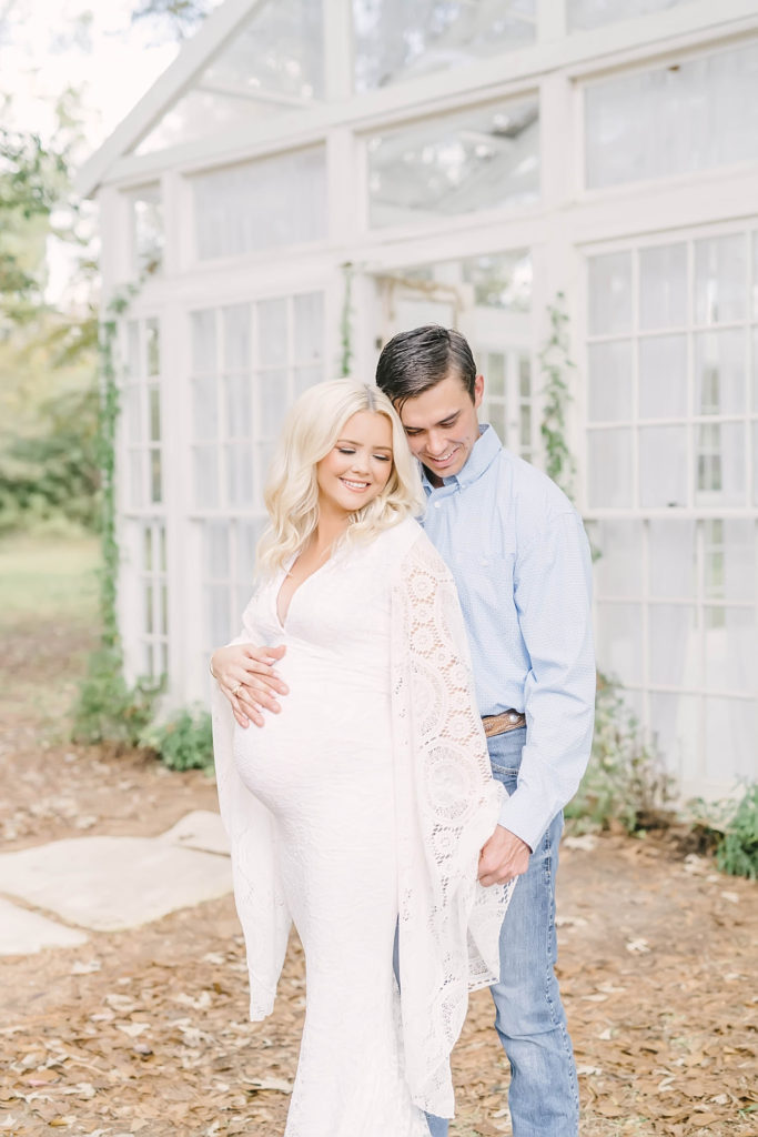 Couple cozies up for an intimate maternity portrait during photos with Christina Elliott Photography.