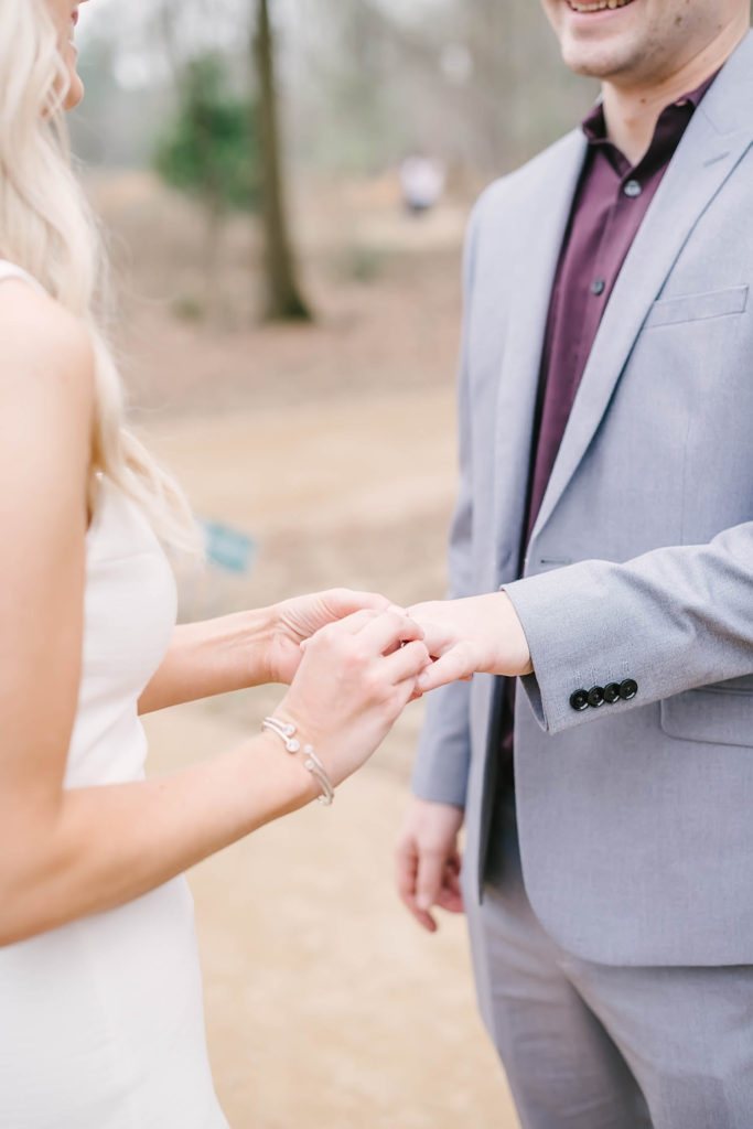Couple exchanges rings during their intimate wedding ceremony at Memorial Park Eastern Glades area of the park. Houston elopement photographer. Houston wedding photographer. Christina Elliott Photography