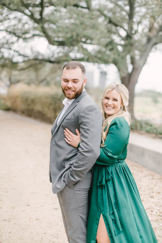 Eleanor Tinsley Park engagement photos with Christina Elliott Photography in downtown Houston wearing a green maxi dress and a gray suit.
