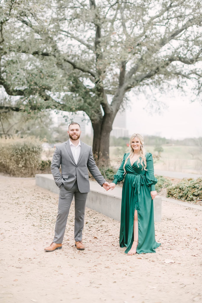 Eleanor Tinsley Park engagement photos with Christina Elliott Photography in downtown Houston wearing a green maxi dress and a gray suit.