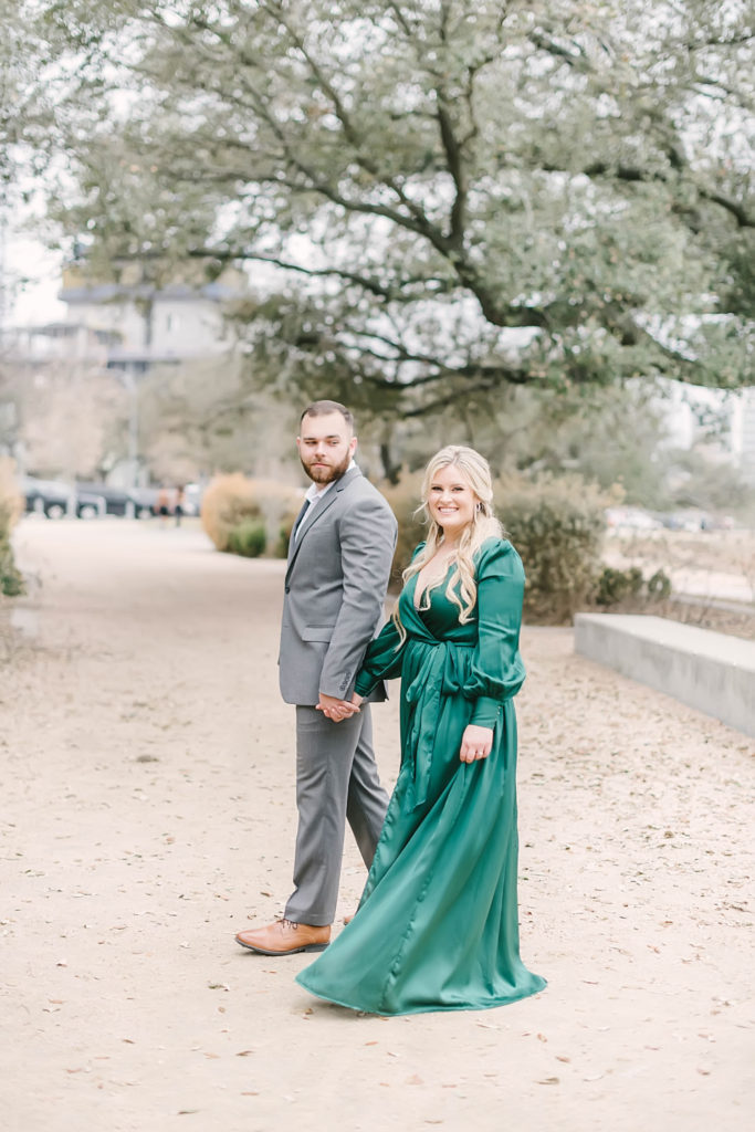 Eleanor Tinsley Park engagement photos with Christina Elliott Photography in downtown Houston wearing a green maxi dress and a gray suit.