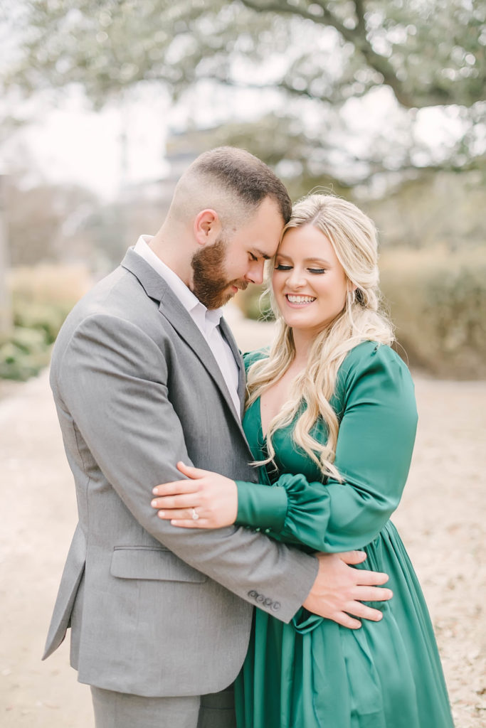 Couple giggle during their downtown Houston engagement photo session with Christina Elliott Photography.