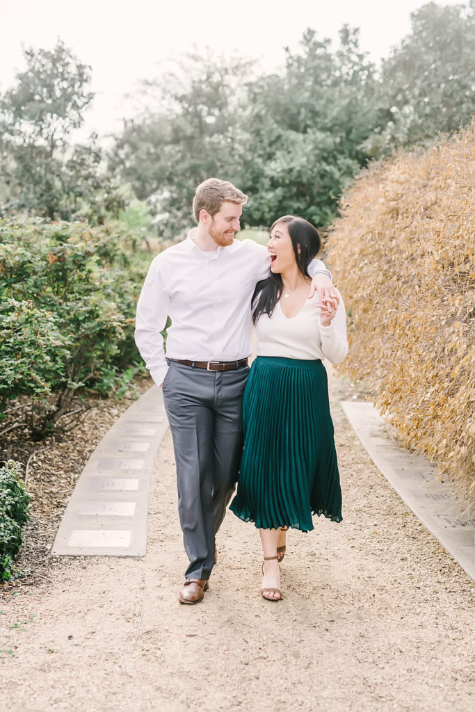 Couple strolls through the garden at Eleanor Tinsley Park during their Downtown Houston engagement session with Houston photographer Christina Elliott Photography.