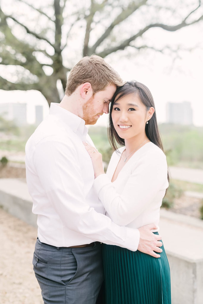 Bride to be smiles at the camera during their engagement session at Eleanor Tinsley Park in Downtown Houston.