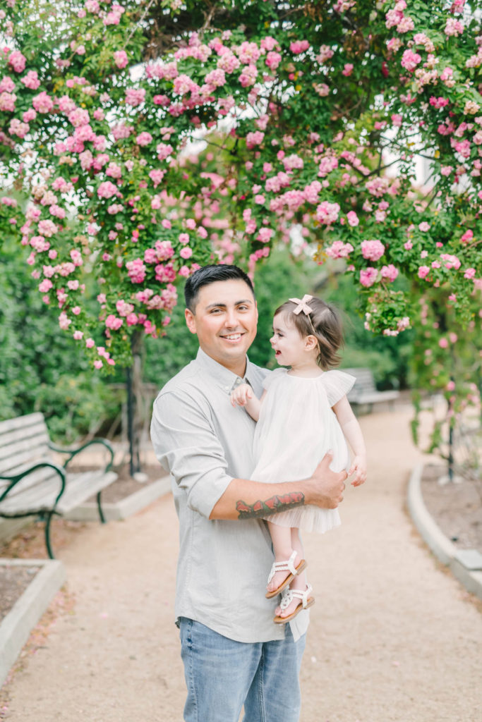 Dad holds his baby girl for family photos at McGovern Centennial Gardens Rose Gardens in Houston with Houston wedding photographer Christina Elliott Photography.