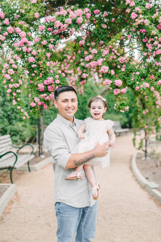 Dad holds his baby girl for family photos at McGovern Centennial Gardens Rose Gardens in Houston with Houston wedding photographer Christina Elliott Photography.