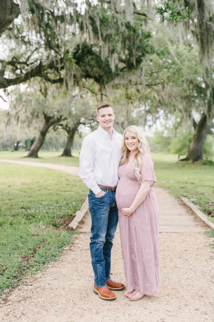 At Brazos Bend State Park in the morning sunlight parents-to-be are captured smiling radiantly by Christina Elliott Photography. nine months pregnant pictures capturing pregnancy pregnancy poses baby girl on the way document pregnancy #christinaelliottphotography #brazosbendstatepark #houstonmaternityphotographer #parentstobe #babybumppicutes #houstonareaphotographer #professionalmaternityphotographer #houstonmaternity #preggo #pregnancyjournal #texasmaternityphotographer
