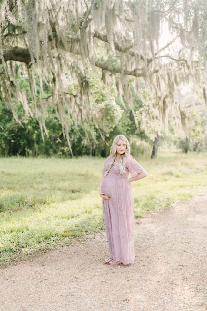 Maternity Photographer Christina Elliott Photography captures a long hair blonde pregnant woman in golden morning sunshine in Houston Texas looking at her baby bump. houston professional portraits pregnant momma #christinaeliottphotography #christinaelliotmaternity #brazosbendstatepark #houstonmaternityphotographer #parentstobe #babybumppicutes #houstonareaphotographer #professionalmaternityphotographer #houstonmaternity #preggo #pregnancyjournal #texasmaternityphotographer