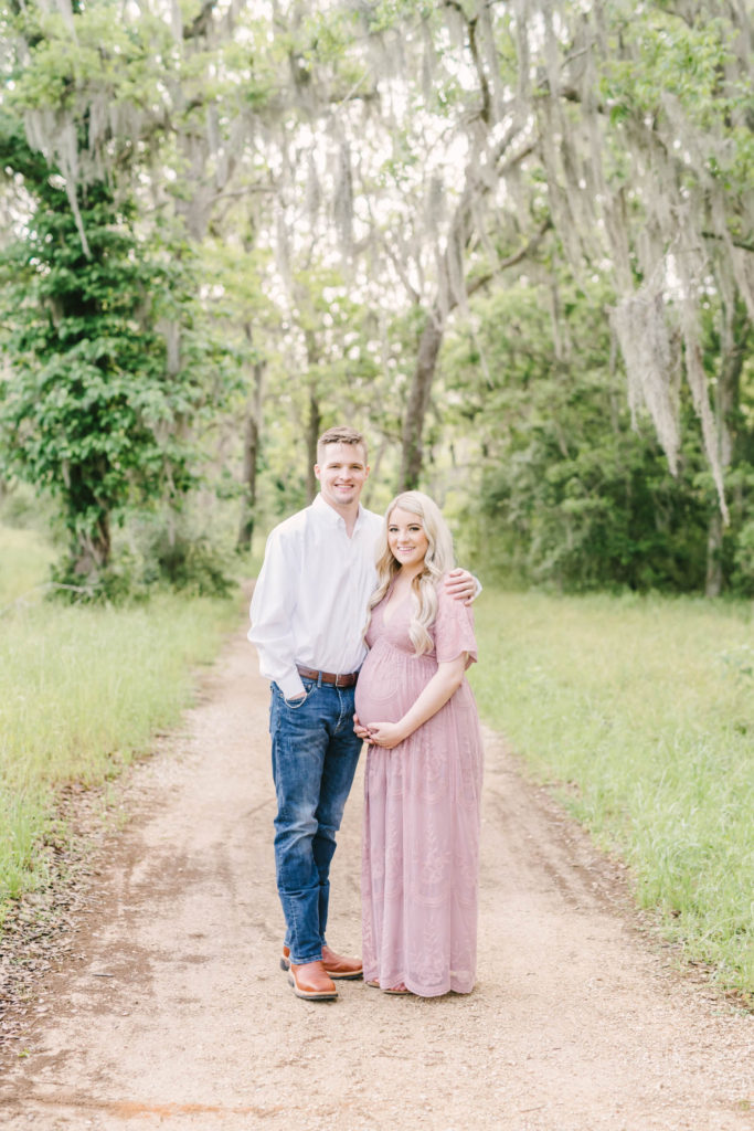 Couple snuggles together for their morning maternity session at Brazos Bend State Park with Christina Elliott Photography, Houston maternity photographer. outdoor maternity session bright and natural editing texas photography #christinaeliottphotography #christinaelliotmaternity #brazosbendstatepark #houstonmaternityphotographer #parentstobe #babybumppicutes #houstonareaphotographer #professionalmaternityphotographer #houstonmaternity #preggo #pregnancyjournal #texasmaternityphotographer