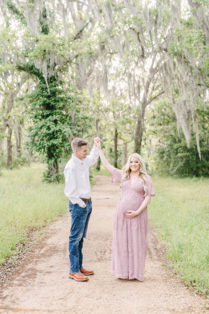 Loving couple dance in the park during their maternity session with Houston wedding photographer Christina Elliott Photography. dancing photo maternity fun poses couple goals couple outfit ideas #christinaeliottphotography #christinaelliotmaternity #brazosbendstatepark #houstonmaternityphotographer #parentstobe #babybumppicutes #houstonareaphotographer #professionalmaternityphotographer #houstonmaternity #preggo #pregnancyjournal #texasmaternityphotographer