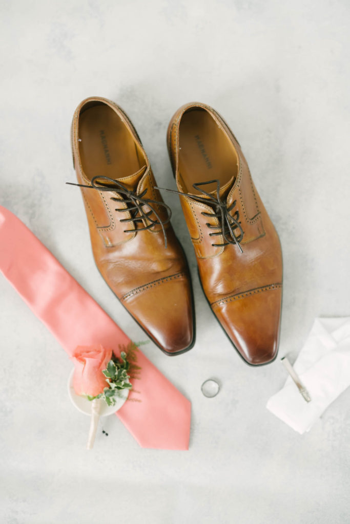 Christina Elliott Photography captures a groom flat-lay photo featuring the groom's shoes, tie, boutineer, ring and hankerchief for a Texas wedding. groom style flat lay ideas manly wedding flat lay groom shoe style #christinaelliotphoto #christinaelliotphotography #christinaelliotelopements #elopementphotographer #wallisvillewedding #houstontexaswedding #houstonweddingphotographer #trinityfarmhouse #texaselopements #elopement #springwedding
