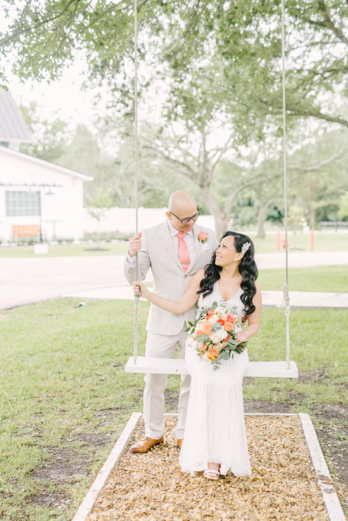 Christina Elliott Photography captures a cute picture during an elopement of the bride sitting on a rope swing looking up into the groom's eyes in Wallisville. rope swing wedding pic groom style ideas wedding love couple poses #christinaelliotphoto #christinaelliotphotography #christinaelliotelopements #elopementphotographer #wallisvillewedding #houstontexaswedding #houstonweddingphotographer #trinityfarmhouse #texaselopements #elopement #springwedding