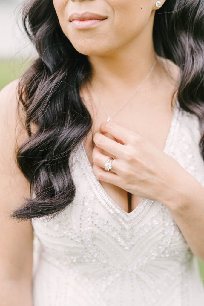 Close-up shot of the bride's beautiful white and silver bead wedding dress, big diamond ring, and gorgeous black hair in Wallisville by Christina Elliott Photography. simple beautiful wedding ring simple wedding hair vintage wedding dress #christinaelliotphoto #christinaelliotphotography #christinaelliotelopements #elopementphotographer #wallisvillewedding #houstontexaswedding #houstonweddingphotographer #trinityfarmhouse #texaselopements #elopement #springwedding