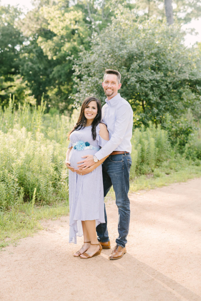 Christina Elliot Photography photographs a gorgeous man and woman in a maternity photoshoot in Texas. purple dress white button down shirt for manposing couple for maternity photoshoot how to dress for maternity shoot summer photoshoot best locations for photoshoot in texas maternity poses for couples baby bump photos happy couple in photoshoot #maternityphotos #maternityphotoshoot #maternityphotographers #texasmaternityphotographers #outfitinspoformaternityphotoshoot