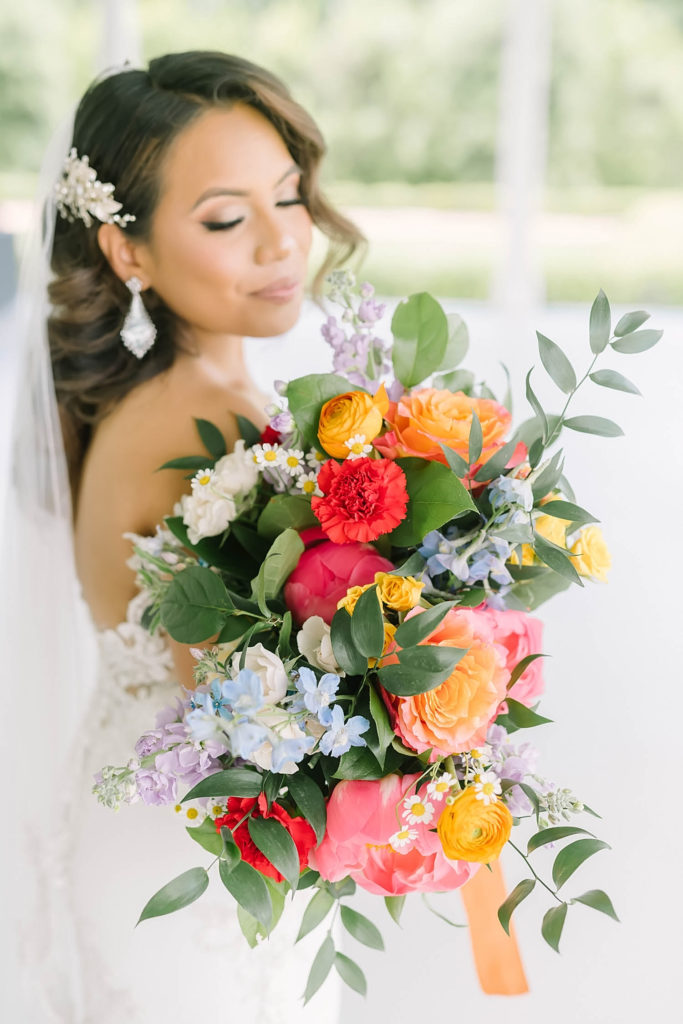 Beautiful bride with red and yellow flowers for a summer farmhouse wedding in Texas by Christina Elliot Photography. red and yellow wedding colors summer wedding colors beautiful bridal poses sweetheart dress for wedding hair inspo for wedding dress inspo for wedding summer wedding ideas how to dress for your wedding mother of the bride outfits #texasweddingphotographer #farmhousewedding #farmhouseweddinginspo #texasphotographer #farmhouseweddingdecor #texasweddinglocations