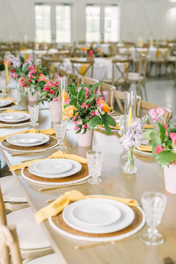 Summer farmhouse wedding in Texas by Christina Elliot Photography perfect table settings with pops of yellow. red and yellow wedding colors summer wedding colors table decor for wedding how to decorate for summer wedding the best wedding colors for the summer how to do a farmhouse wedding colors for wedding red and yellow and orange #texasweddingphotographer #farmhousewedding #farmhouseweddinginspo #texasphotographer #farmhouseweddingdecor #texasweddinglocations