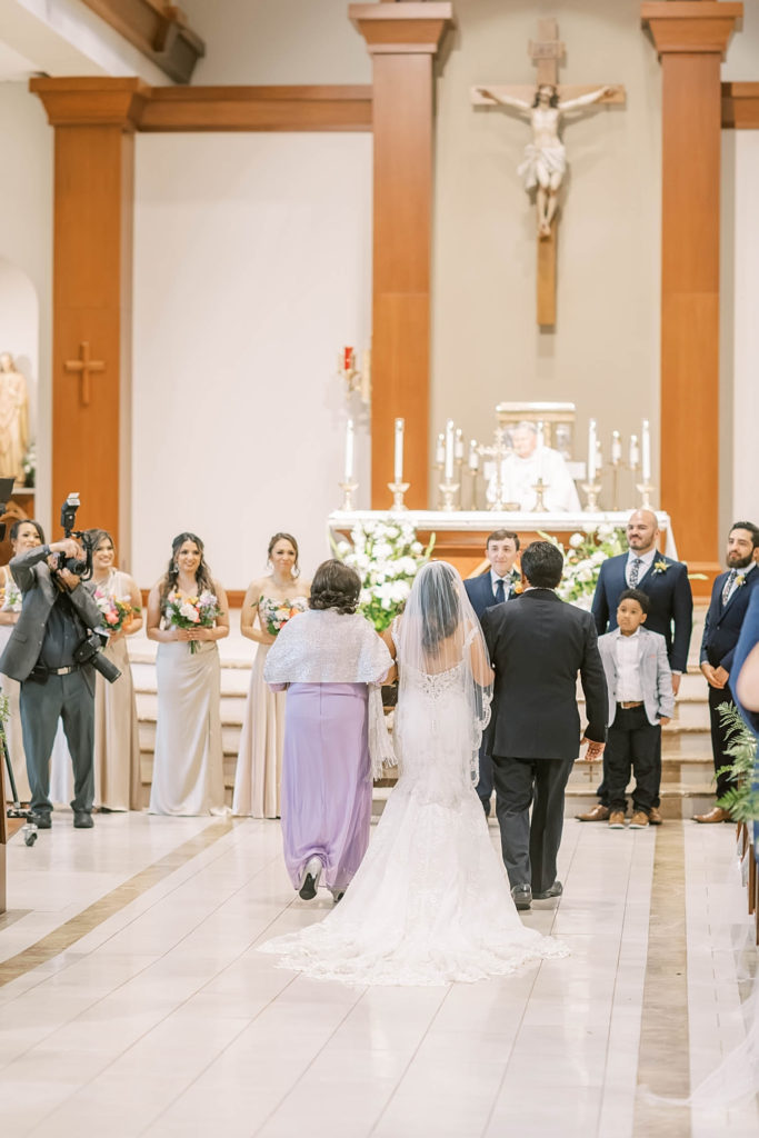 Beautiful photo of parents walking down the altar in a church wedding for a farmhouse summer wedding in Texas by Christina Elliot Photography. church weddings wedding party poses photographing the ceremony how to dress the wedding party farmhouse wedding decor inpso summer wedding colors altar pictures wedding ceremony photos #texasweddingphotographer #farmhousewedding #farmhouseweddinginspo #texasphotographer #farmhouseweddingdecor #texasweddinglocations