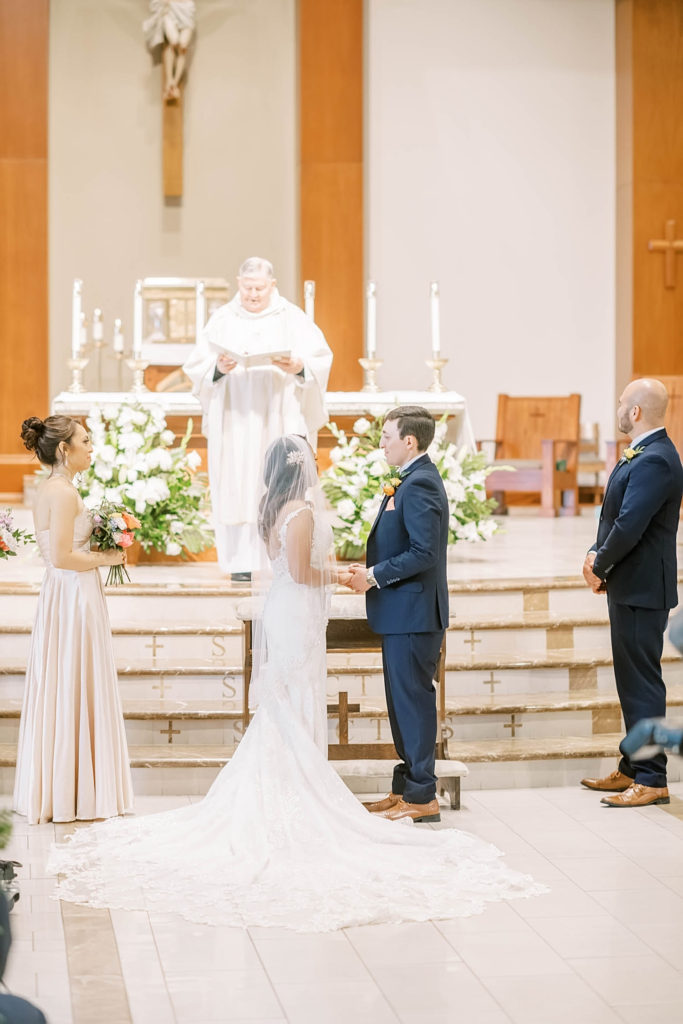Beautiful photo of wedding ceremony of couple standing at the altar in a church wedding for a farmhouse summer wedding in Texas by Christina Elliot Photography. church weddings wedding photographing the ceremony farmhouse wedding decor inpso summer wedding colors altar pictures wedding ceremony photos marrying at the altar photos #texasweddingphotographer #farmhousewedding #farmhouseweddinginspo #texasphotographer #farmhouseweddingdecor #texasweddinglocations