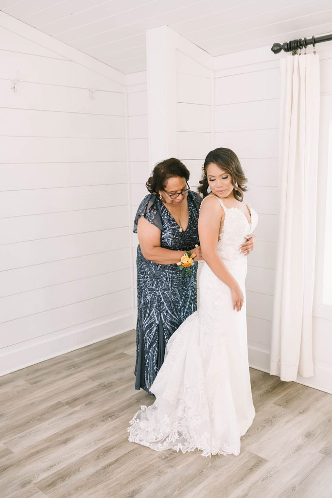Beautiful mom and daughter in getting ready photos for summer farmhouse wedding in Texas by Christina Elliot Photography. mom and daughter photos for wedding getting ready photos candid wedding photos beautiful bridal poses sweetheart dress for wedding hair inspo for wedding dress inspo for wedding summer wedding ideas how to dress for your wedding mother of the bride outfits #texasweddingphotographer #farmhousewedding #farmhouseweddinginspo #texasphotographer #farmhouseweddingdecor #texasweddinglocations
