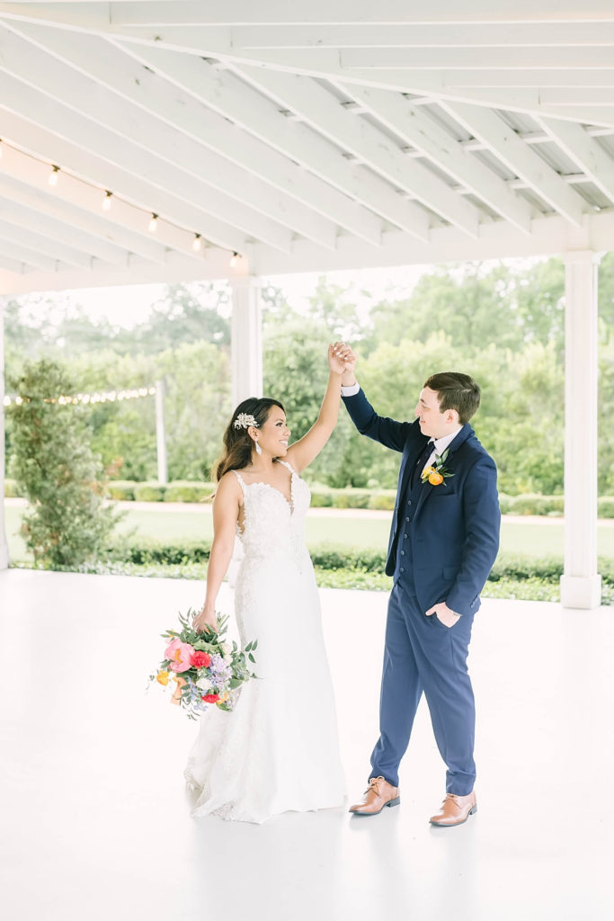 Cute dancing pose of bride and groom in a perfect farmhouse summer wedding by Christina Elliot Photography in Texas. poses for bride and groom farmhouse wedding how to dress for a summer wedding outfits for bride and groom poses for bride and groom classic wedding dress for bride classic suit for groom summer outfits for wedding white barn wedding #texasweddingphotographer #farmhousewedding #farmhouseweddinginspo #texasphotographer #farmhouseweddingdecor #texasweddinglocations